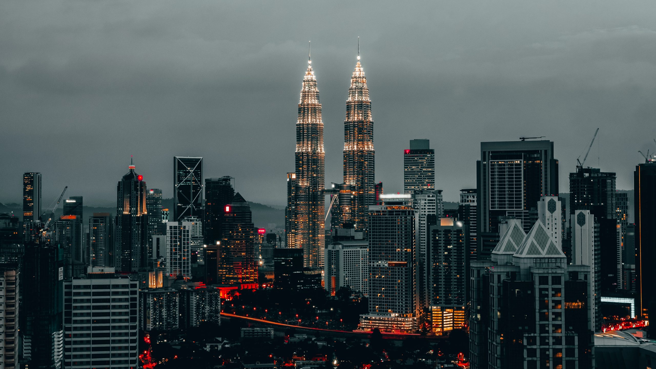 Petronas Towers at night along with wider cityscape